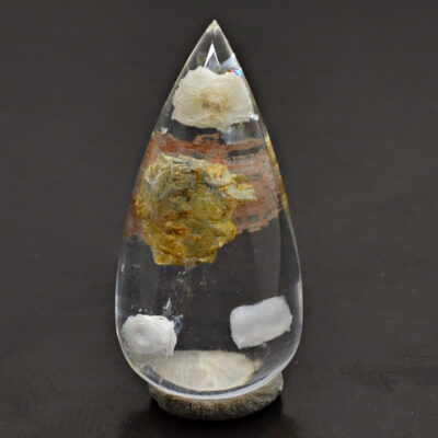 A tear shaped piece of quartz on a table.