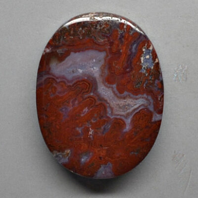 A red and brown agate cabochon.