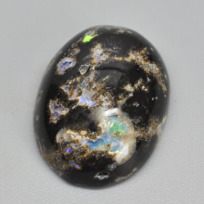 A black and white opal on a white surface.