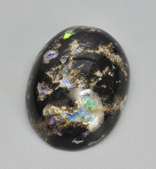 A black and white opal on a white surface.