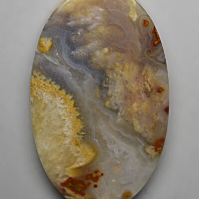 An oval piece of agate on a white surface.