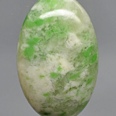 A green and white jade cabochon.