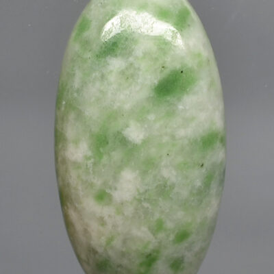 A green jade stone on a white background.