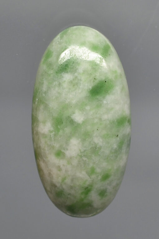 A green jade stone on a white background.