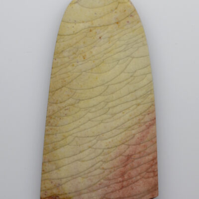 A piece of stone with a pink and yellow color.