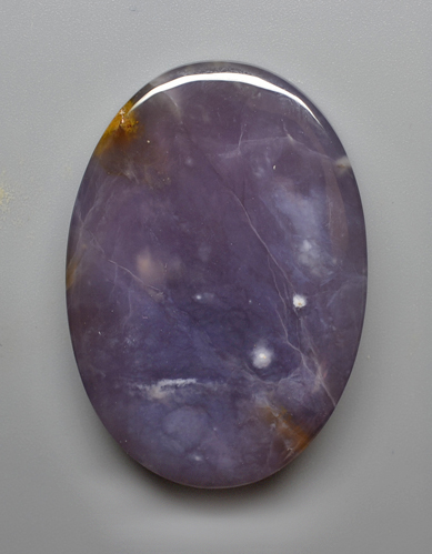 A purple stone with yellow spots on it.
