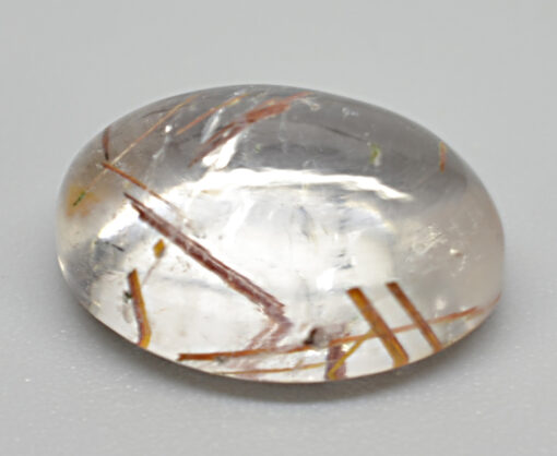 A clear quartz stone with a lot of grass on it.