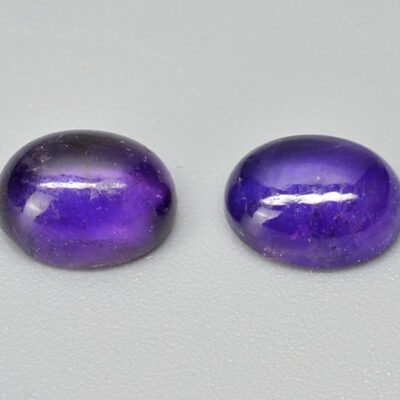 A pair of purple amethyst cabochons.