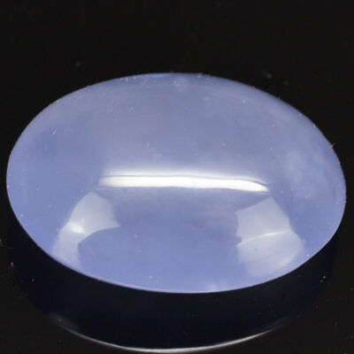 A blue jade stone on a black surface.