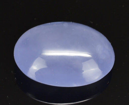 A blue jade stone on a black surface.