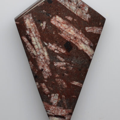 A triangular piece of brown and white marble.