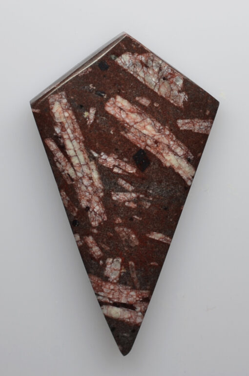 A triangular piece of brown and white marble.