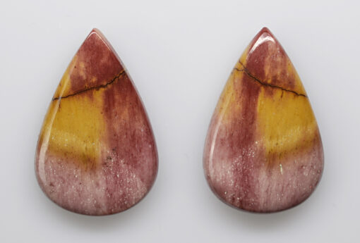 A pair of red and yellow tear shaped stones.