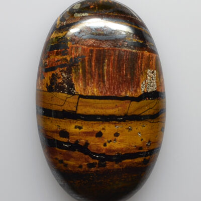 A tiger's eye stone on a white background.
