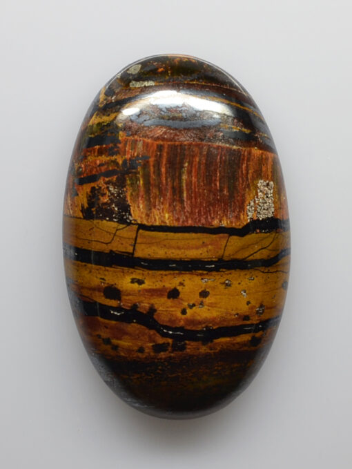 A tiger's eye stone on a white background.