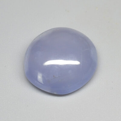 A blue jade stone on a white surface.