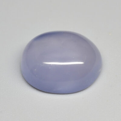 A purple jade stone on a white surface.