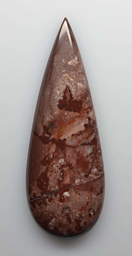 A piece of brown jasper on a white background.