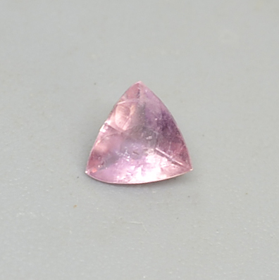 A pink stone with a triangle shape.