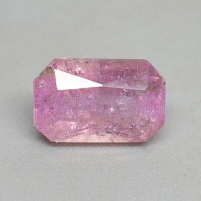 An emerald cut pink sapphire stone.