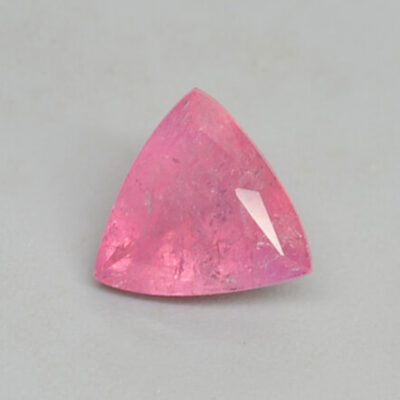 A pink tourmaline stone in a triangular shape, available for purchase.