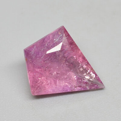 A pink sapphire cut into a triangle shape.