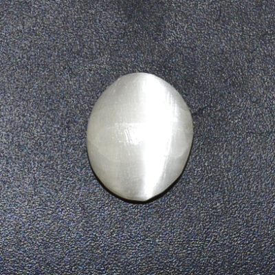 A white stone on a black surface.