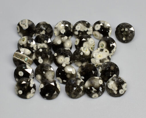 A group of black and white diamonds on a white surface.