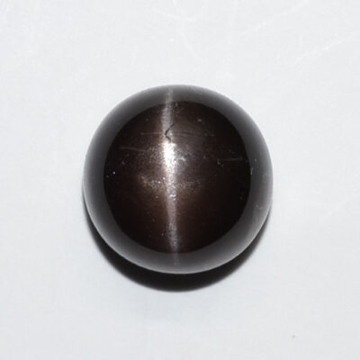 A black stone ball on a white surface.