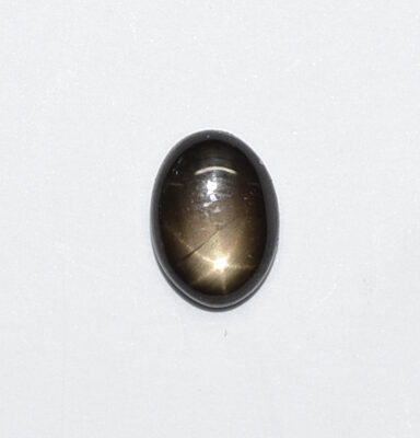 A brown stone with a black star in the middle.