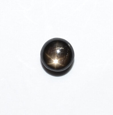 A black ball with a light shining on it.
