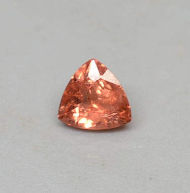 An orange colored diamond in a triangular shape.