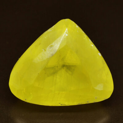 A yellow sapphire in a triangular shape.