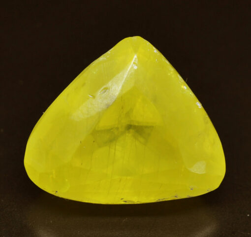 A yellow sapphire in a triangular shape.