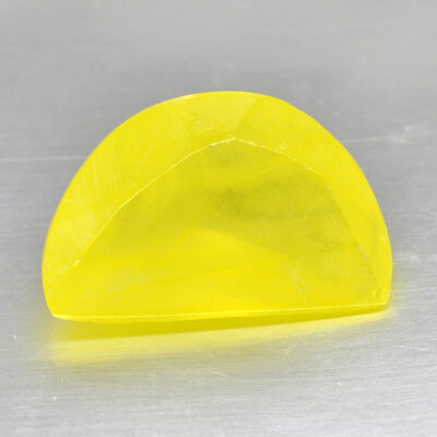 A yellow piece of plastic sitting on a surface.