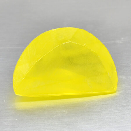 A yellow piece of plastic sitting on a surface.